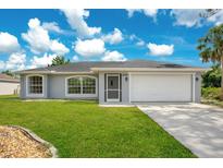 Charming single-story home featuring a well-maintained lawn and an attached two-car garage at 2706 Flagami Ln, North Port, FL 34286