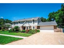 Charming two-story home featuring a well-manicured front yard and attached two car garage at 3009 Ridgevale Cir, Valrico, FL 33596
