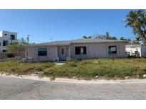 Charming single-story home featuring a classic design with a well-manicured lawn at 365 145Th E Ave, Madeira Beach, FL 33708