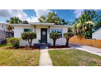 Charming home with a white exterior, manicured landscaping, and a welcoming front porch with decorative wreath at 2456 S 17Th S Ave, St Petersburg, FL 33712