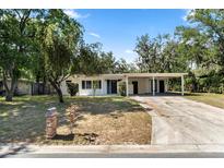 Charming single-story home featuring a carport, brick mailbox, and welcoming curb appeal at 404 Courtney Dr, Temple Terrace, FL 33617