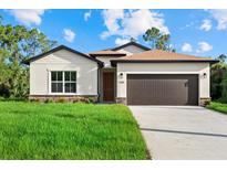 Charming single-Gathering home boasting well-manicured lawn and inviting curb appeal at 1240 Baywood Dr, North Port, FL 34288