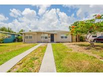 Charming single story home featuring a well-maintained lawn and long driveway at 1020 58Th N Ave, St Petersburg, FL 33703