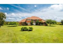 Stunning two-story home with a tile roof and expansive green lawn at 37511 Washington Loop Road, Punta Gorda, FL 33982