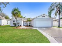 Charming single-story home featuring a two-car garage, well-maintained lawn, and beautiful palm trees at 11212 3Rd E Ave, Bradenton, FL 34212