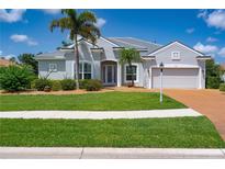 Beautiful single-story home featuring a well-maintained lawn, lush landscaping, and a two-car garage at 1751 Bobcat Trl, North Port, FL 34288
