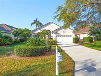 Charming home with well-manicured front yard, lush landscaping, and a two-car garage at 6504 Virginia Xing, University Park, FL 34201