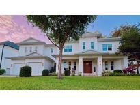Stunning two-story white home boasts a manicured lawn and charming front porch at 4309 W Beachway Dr, Tampa, FL 33609