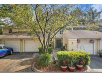Charming townhome with well-manicured landscaping and attached garage, perfect for suburban living at 11239 Cedar Hollow Ln, Tampa, FL 33618