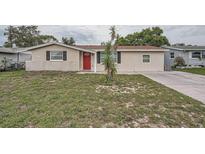 Charming single-story home with neutral paint, brick accents, and a well-maintained lawn at 5429 Flora Ave, Holiday, FL 34690