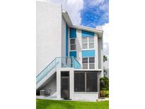 Blue and white condo building with sunny sky and blue accents on balconies and trim at 215 Medallion Blvd # G, Madeira Beach, FL 33708