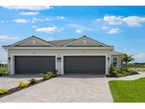 Charming home with a two car garage, paver driveway, and well manicured lawn at 3142 Torta Ct, Bradenton, FL 34211