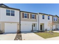 Charming townhomes feature attached garages, well-manicured lawns and inviting exteriors at 6166 Daerr Ridge St, Zephyrhills, FL 33542