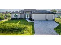 Charming single-story home features lush front yard, paved driveway, and a welcoming entrance at 9257 King Hill St, Port Charlotte, FL 33981
