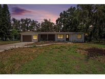 Charming single-story home featuring a well-manicured lawn and inviting curb appeal with tasteful landscaping at 14050 Blackjack Rd, Dover, FL 33527