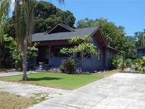 Charming blue bungalow featuring a well-manicured lawn and inviting curb appeal at 834 Jackson N St, St Petersburg, FL 33705