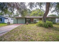 Charming single-story home with attached garage and mature landscaping at 101 N Nimbus Ave, Clearwater, FL 33765