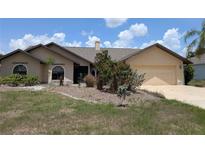 Charming single-story home featuring a well-maintained yard and attached two-car garage in a lovely neighborhood at 141 Angol St, Punta Gorda, FL 33983