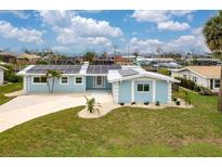 Charming single-story home featuring solar panels and a well-manicured lawn at 1764 Boca Raton Ct, Punta Gorda, FL 33950