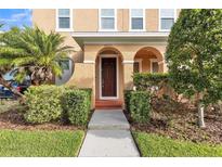 Inviting home entrance with manicured bushes and a well-maintained lawn at 32717 Coldwater Creek Loop, Wesley Chapel, FL 33545