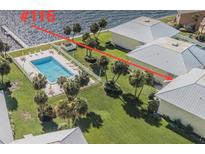 Community with pool, waterway access, landscaping, and multiple residential buildings at 7310 Sunshine Skyway S Ln # 116, St Petersburg, FL 33711