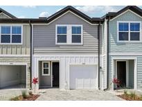 Charming two-story townhome with a one-car garage and neutral gray siding at 7292 Deer Valley Circle, Tampa, FL 33635