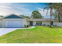 Charming single-story home featuring a well-manicured lawn and a cozy, inviting exterior with attached garage at 221 Vermont E Ave, Bradenton, FL 34208