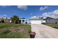 Charming single-story home with a front lawn and attached garage at 249 Malvern Dr, Venice, FL 34293