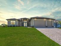Charming single-story home with a lush green lawn and a welcoming front entrance at 9573 Migue Cir, Port Charlotte, FL 33981