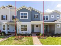 Attractive townhome with blue and gray exterior, covered porch, and well-maintained landscaping at 17330 Alderwood Ln, Punta Gorda, FL 33982