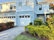 Charming two-story home with a private residence sign, beautiful garden, and a two-car garage at 4171 Via Sienna Cir, Sarasota, FL 34243