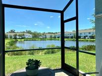 Screened-in patio offers tranquil views of the pond and surrounding community at 4171 Via Sienna Cir, Sarasota, FL 34243