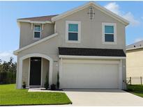 Charming two-story home with a well-manicured lawn, and a two car garage at 5150 San Palermo Dr, Bradenton, FL 34208