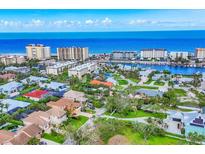 Stunning aerial view showcasing the oceanfront community with beautiful homes and ocean views at 811 Laguna Dr, Venice, FL 34285