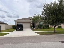 Charming single Gathering home features a well-maintained lawn and a two-car garage at 13642 Newport Shores Dr, Hudson, FL 34669