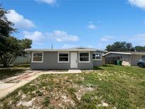 Charming home featuring a front yard with green grass and a neatly painted exterior with white trim at 4432 W Wallace Ave, Tampa, FL 33611