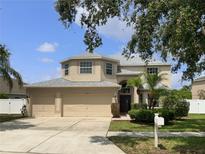 Charming two-story home with three car garage, manicured lawn and mature landscaping at 11356 Callaway Pond Dr, Riverview, FL 33579