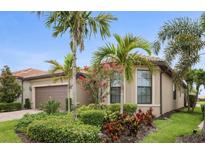 Charming single-story home with lush landscaping and swaying palm trees, offering a tranquil curb appeal at 13084 Rinella St, Venice, FL 34293