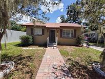 Charming single-story home featuring a brick walkway, lovely landscaping, and a durable metal roof at 13 Euclid Dr, Plant City, FL 33563