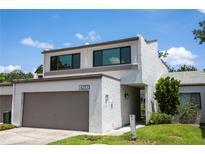 Charming two-story home with a large garage and well-maintained lawn and landscaping at 4203 Fairway Run, Tampa, FL 33618