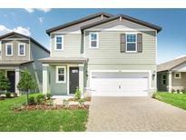 Charming two-story home boasts a well-manicured lawn, two-car garage and welcoming front porch at 1844 Brekey Way, Zephyrhills, FL 33541