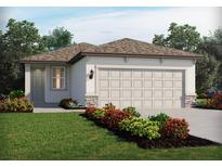 Charming single-story home featuring a well-manicured lawn and an attached two-car garage at 3660 Moscato Dr, Brooksville, FL 34602