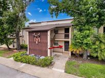 Inviting condo exterior with mature landscaping and a private entrance, unit 4 at 1200 Tarpon Woods Blvd # L4, Palm Harbor, FL 34685
