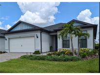 Charming one-story home featuring a well-manicured lawn, elegant landscaping, and a two-car garage at 2729 Gabel Oak Dr, North Port, FL 34289