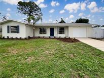 Charming single-story home featuring a well-manicured lawn and attached one car garage at 5629 Nutmeg Ave, Sarasota, FL 34231