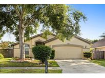 Charming one-story home with a well-maintained lawn, mature trees, and an attached two-car garage at 1716 Westerly Dr, Brandon, FL 33511
