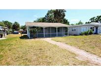 Charming single story home featuring a screened-in porch and welcoming brick walkway at 530 74Th N Ave, St Petersburg, FL 33702