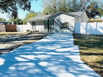 Charming single-story home featuring a freshly painted exterior, new driveway, and well-maintained landscaping at 6320 Cedar St Ne, St Petersburg, FL 33702