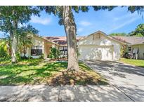 Charming single-story home with a well-maintained lawn and mature landscaping at 2556 Arborwood Dr, Valrico, FL 33596