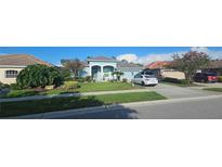 Charming one-story home featuring a well-manicured lawn, inviting curb appeal, and a two-car garage at 1884 Coconut Palm Cir, North Port, FL 34288